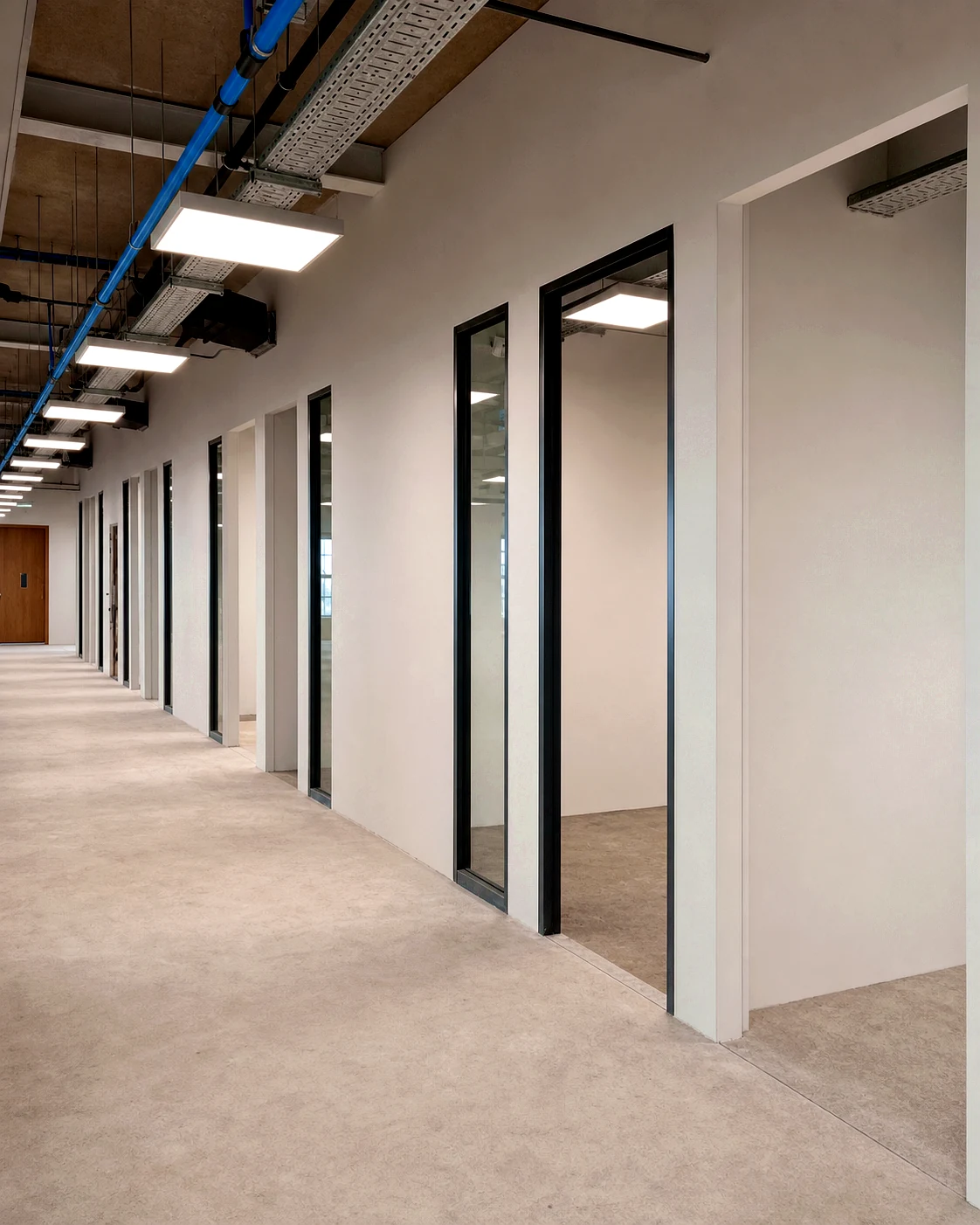 Commercial corridor with completed partition walls and service installations